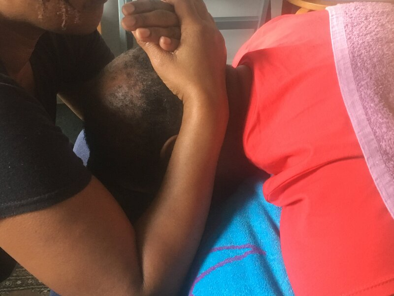 Woman performing Indian Head Massage on man
